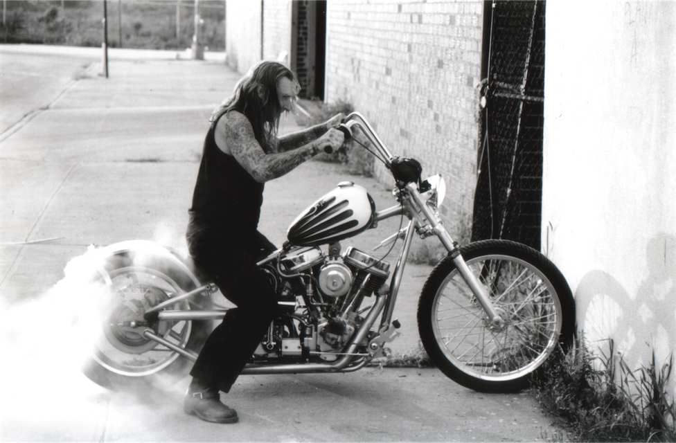 Indian Larry doing a burnout with the Greasy Monkey motorcycle