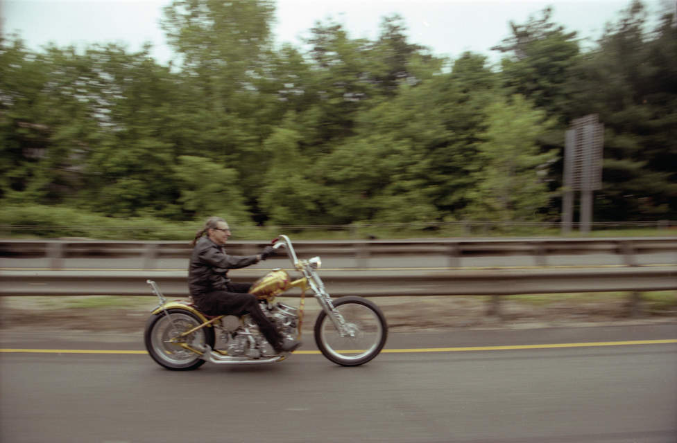 Indian Larry riding the Daddy O motorcycle on a highway